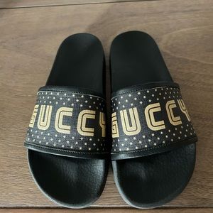 Gucci slides, theGUCCY word written on the front. Gucci x SEGA collaboration.